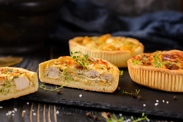 Meat mini pie on the wooden board on table background, closeup with copy space, rustic style