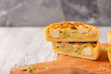 Meat mini pie on the wooden board on white table background, closeup with copy space, rustic style