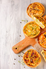 Meat mini pie on the wooden board on white table background, closeup with copy space, rustic style