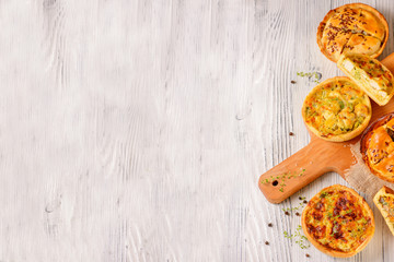 Meat mini pie on the wooden board on white table background, closeup with copy space, rustic style