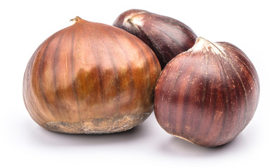 Fototapeta premium Roasted chestnuts served in chestnut pan on an old table