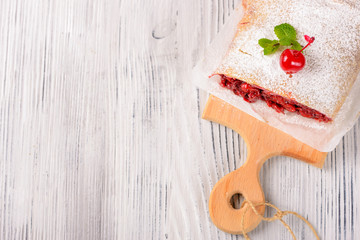Sliced cherry strudel on a wooden board