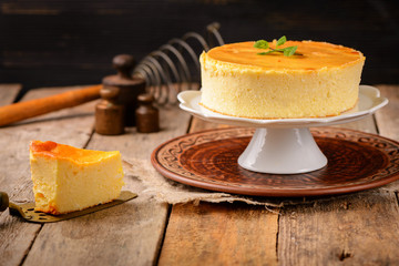 Homemade round cheesecake with mint for dessert - healthy organic summer dessert pie cheesecake. Country style.