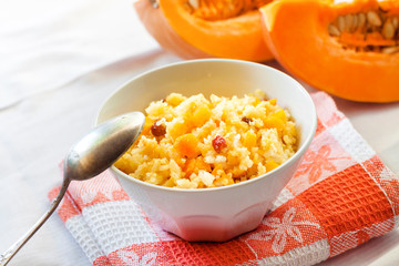 Milky cereal porridge with pumpkin and raisins