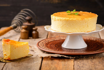 Homemade round cheesecake with mint for dessert - healthy organic summer dessert pie cheesecake. Country style.