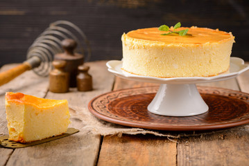 Homemade round cheesecake with mint for dessert - healthy organic summer dessert pie cheesecake. Country style.