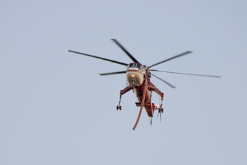 Water Dropping Helicopter in Flight over California Woolsey Fire
