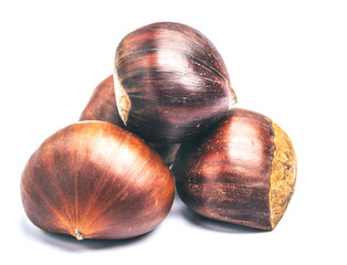 Roasted chestnuts served in chestnut pan on an old table
