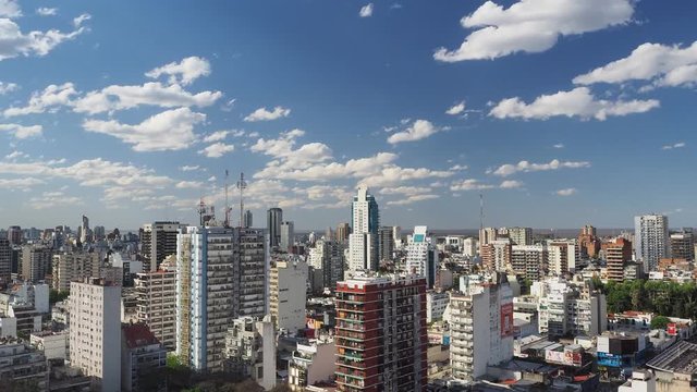 timelapse of summer clouds drifting  over Belgrano neighborhood skyline of Buenos Aires city with many skyscrapers