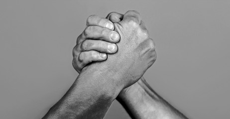 Man hand. Two men arm wrestling. Arms wrestling. Closep up. Friendly handshake, friends greeting, teamwork, friendship. Handshake, arms, friendship. Hand, rivalry, vs, challenge, strength comparison