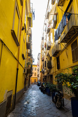 Fototapeta na wymiar Narrow street in old town of Naples city in Italy