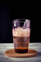glass of beer, wooden table, foam, black background