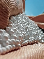 zoomed white expanded polystyrene pellets for production plastic bags.Polystyrene pellets on bright...