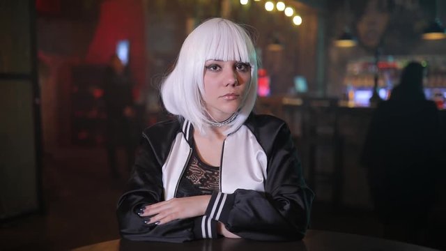 Sexy unusual blonde girl portrait gazing at me in a bar