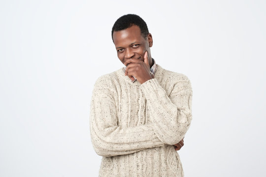 Young African Man Laughing And Covering His Mouth With Hand Over White Background.