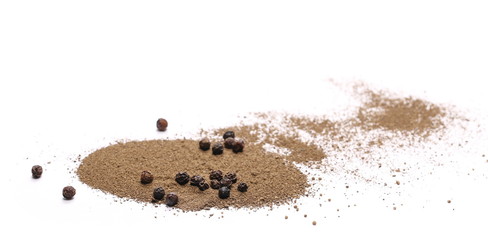Black ground pepper and grain isolated on white background