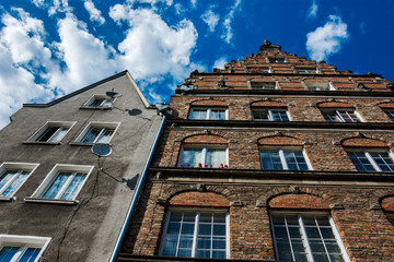 Beautiful view of Main Town of Gdansk , Poland, with ornate houses and amazing white clouds on a blue sky.