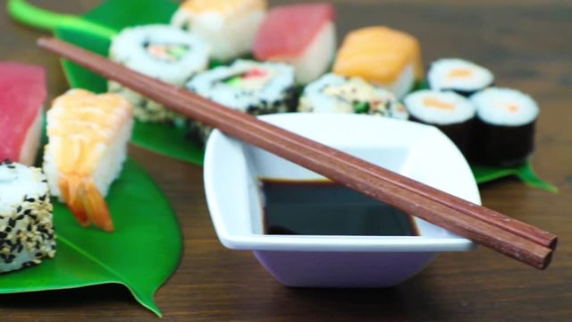 Maki and nigiri sushi set on green leaf background. Close up 