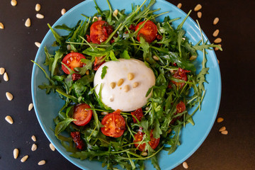 Top view of Burrata cheese salad with cherry tomatoes