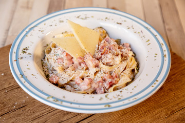 Carbonara spaghetti plate on a wooden table