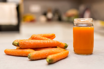 Carrots and fresh juice on the grey concrete table