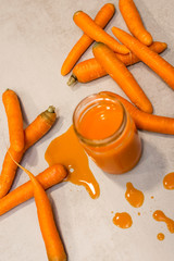 Carrots and fresh juice on the grey concrete table
