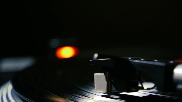 Closeup needle on spinning vintage vinyl record on turntable
