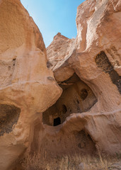 Close up view from the structure of Cappadocia. Impressive fairy chimneys of sandstone in the canyon near Cavusin village, Cappadocia, Nevsehir Province in the Central Anatolia Region of Turkey.