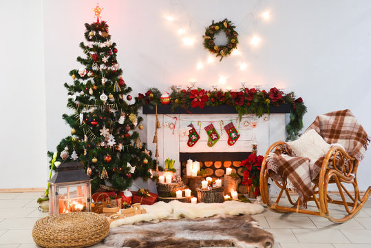 interior photo studio with Christmas decor. Fireplace, Christmas tree, gifts of the New Year's scenery