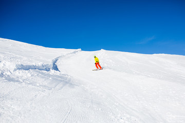 Photo from afar skier in snowy resort