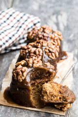 Sticky chocolate and walnut puddings on wooden table