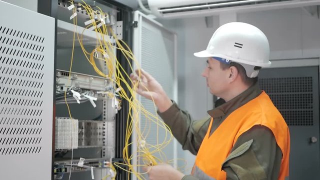 Technicians are installing optic fiber with cable ties.