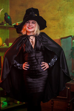 Picture of smiling witch in black hat, dress