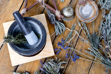 Mortar and Pestle with dried herbs, brass bell, quartz crystal