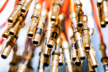 Naklejka premium Miniature brass pins connectors, close-up