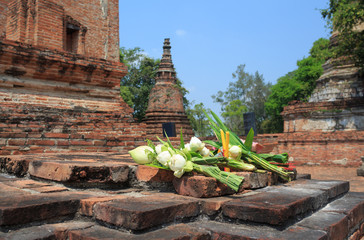 incense candle and white lotus for pray on ancient brick wall temple