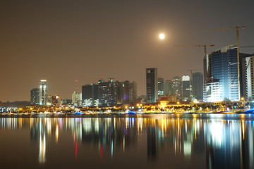 Long exposure night view of Marginal de Luanda with full moon and Mars moments before lunar eclipse