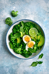 Green vegetable salad with avocado, broccoli, pea and boiled eggs.Top view with copy space.