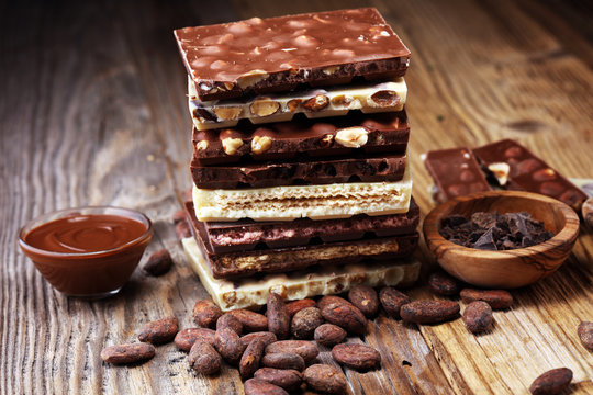 Chocolate bars on table with chocolate tower.