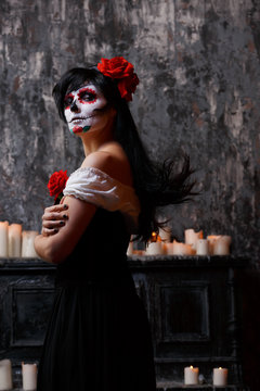 Photo of girl with white make-up and roses on face , arms crossed