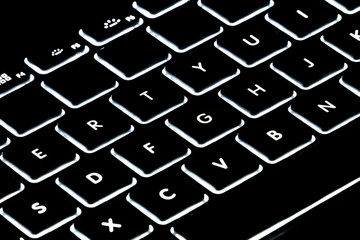 illuminated keyboard on a black background, computer equipment