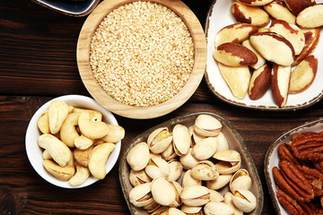 nuts composition on rustic table with walnut and peanut.