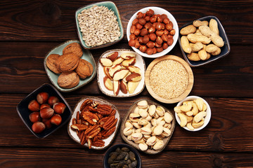 nuts composition on rustic table with walnut and peanut.
