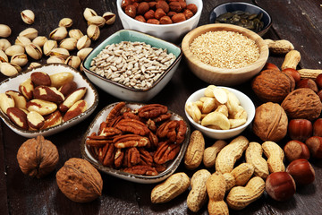 nuts composition on rustic table with walnut and peanut.