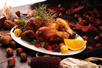 Baked turkey or chicken. The Christmas table is served with a turkey, decorated with fruits, salad and nuts. Fried chicken, table. Christmas dinner