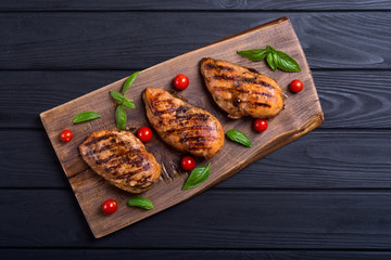 Grilled chicken breast ( fillet ) with basil and tomatoes