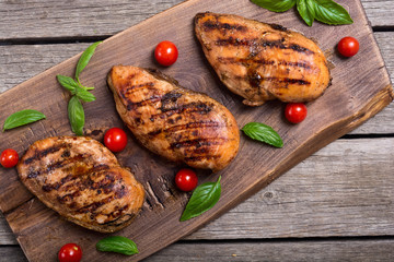 Grilled chicken breast ( fillet ) with basil and tomatoes