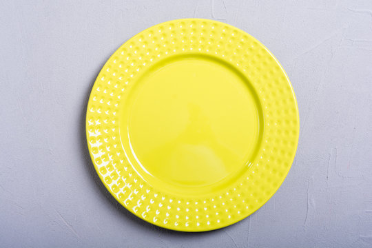 Empty Yellow Plate On Wooden Table