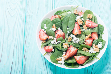 Strawberry salad with spinach , cheese and walnut . Healthy food