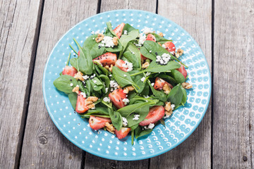 Strawberry salad with spinach , cheese and walnut . Healthy food